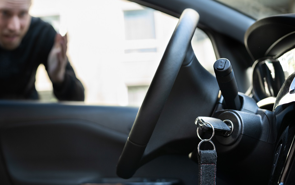 Technician unlocking car and replacing keys on site
